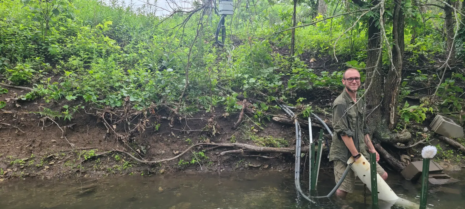 Connor standing in Kings Creek doing sensor maintenance